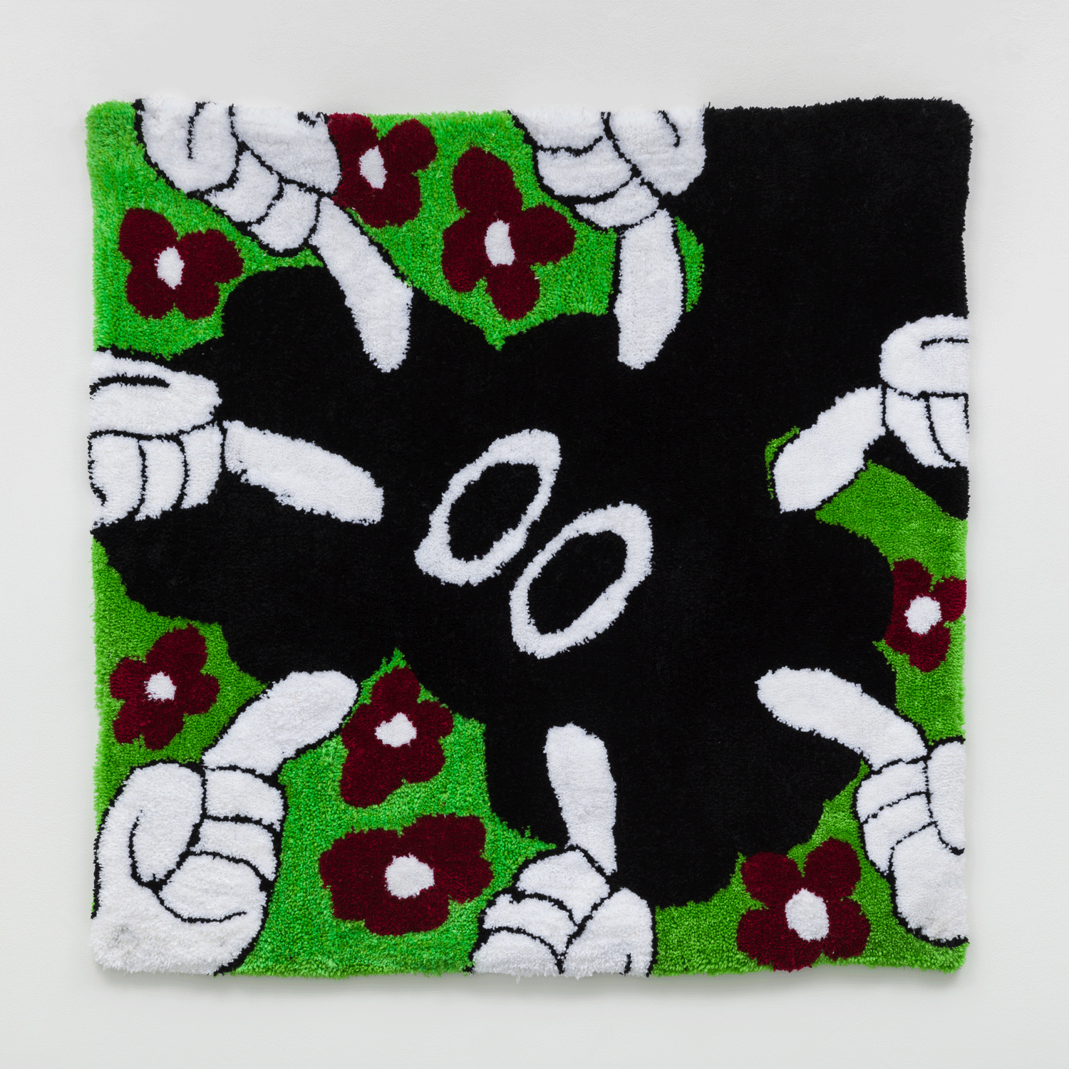 A tapestry of a black figure surrounded by purple flowers and being pointed at by white fingers
