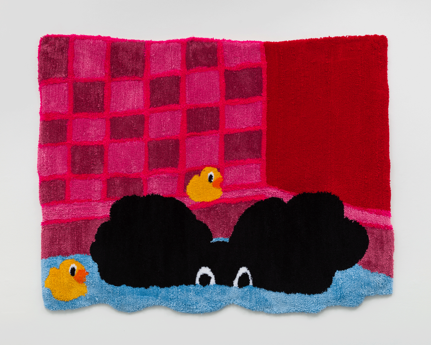 A tapestry of a black figure in a bath, surrounded by pink tile and rubber ducks