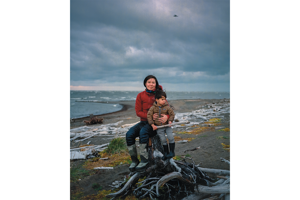 Inupiaq writer Laureli Ivanoff and her son, Henning Nelson, on the windswept shore of Unalakleet, Alaska. Ivanoff explains that climate change is threatening some of her community’s most important subsistence traditions, especially the annual hunt for ugruk (bearded seal). She described a profound sense of loss that her son, already passionate about hunting, may never have the chance to hunt for seal if sea ice continues to disappear
