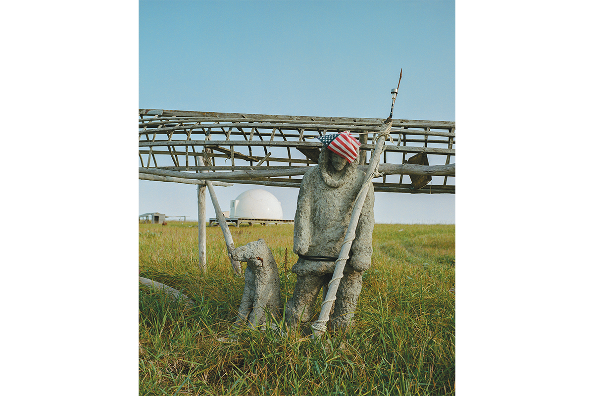 A sculpture of an Inupiaq hunter, together with the frame of an Umiak (traditional boat), mark the entrance to a private camp near Safety Sound, Alaska. This protected lagoon and migratory bird habitat near Nome has been a hunting, fishing and gathering ground for Alaska Native peoples for millennia.