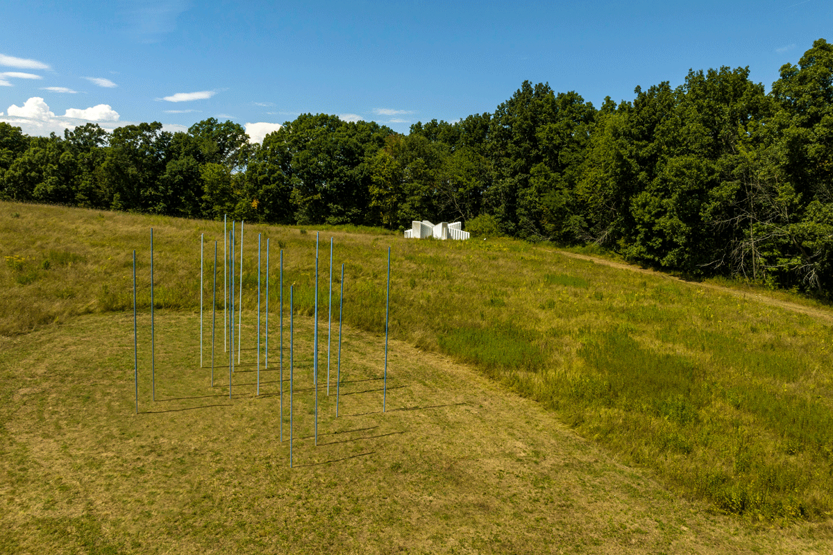 An arrangement of 17 blue and white reeds outdoors