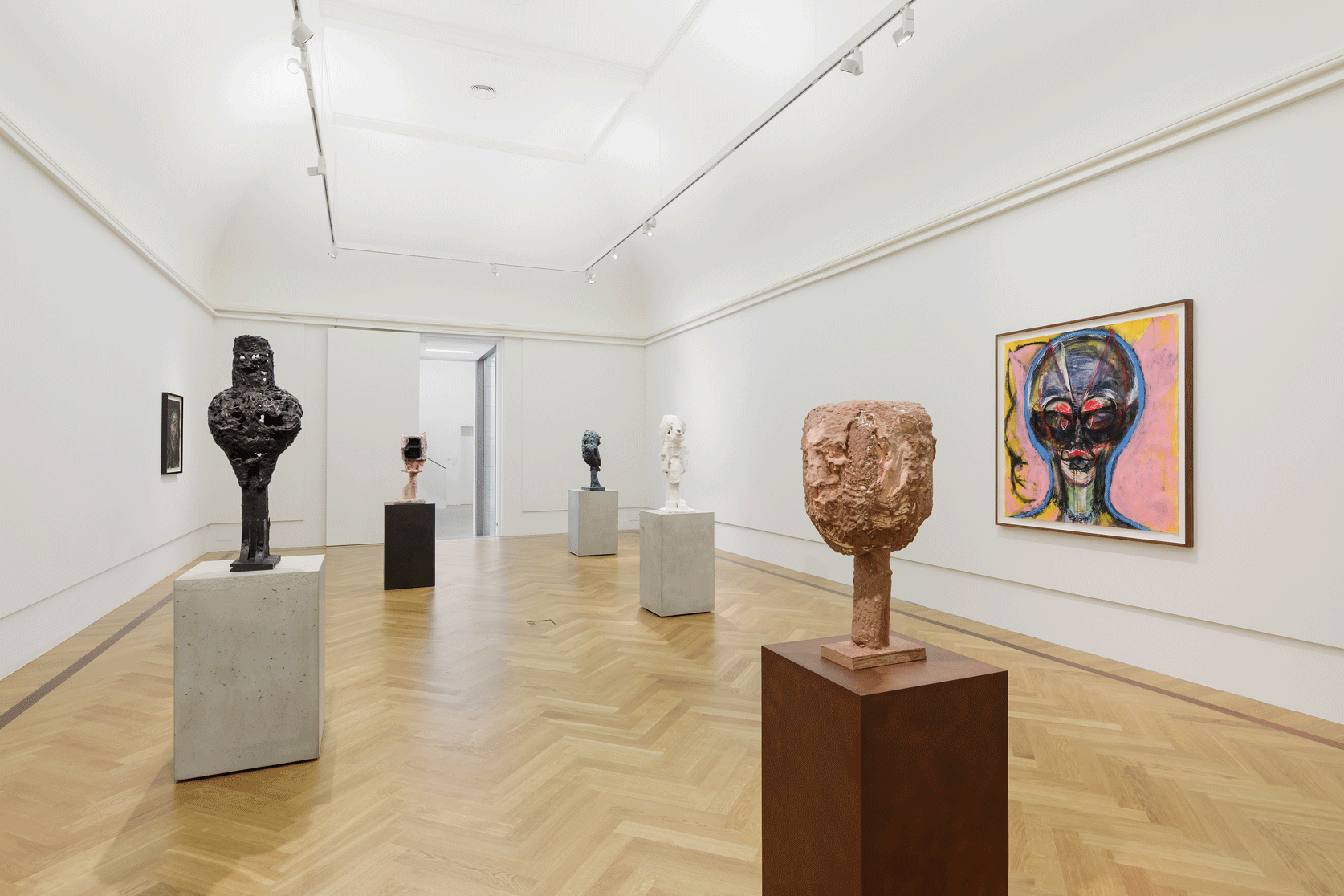 Five sculptures and one painting in a gallery