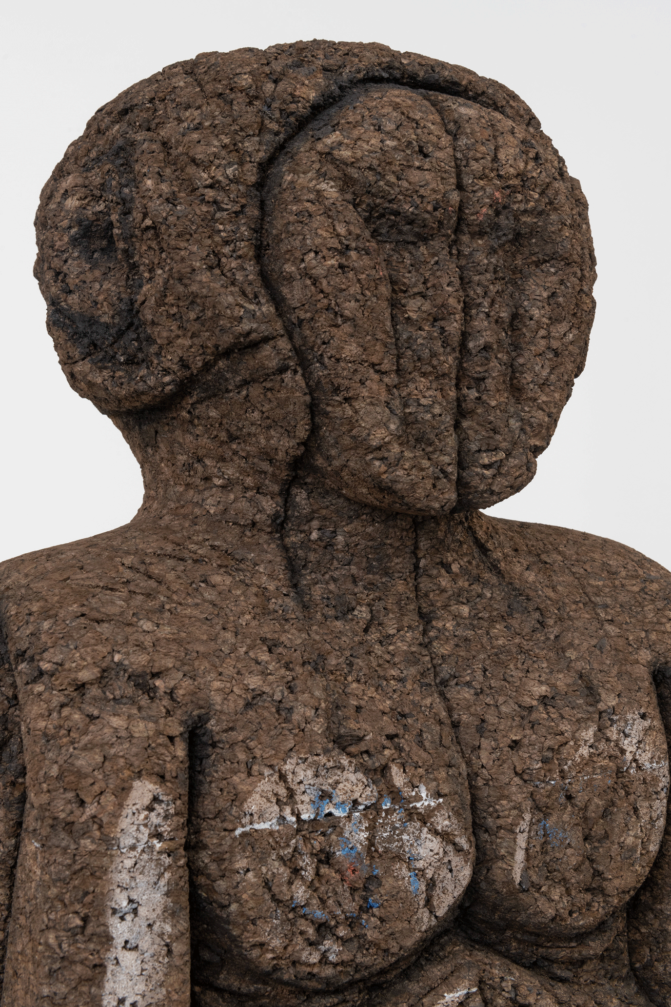 The head and torso of a brown human sculpture