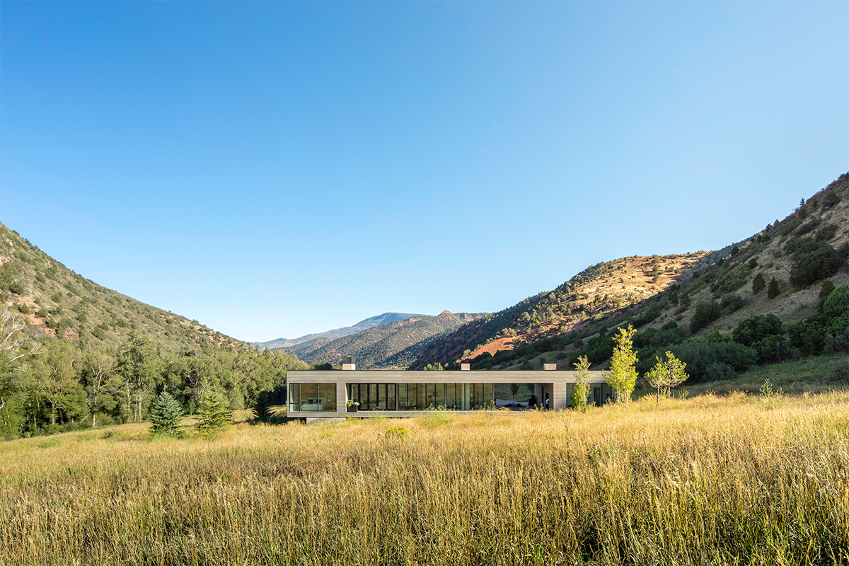 A house in a field of dry grass