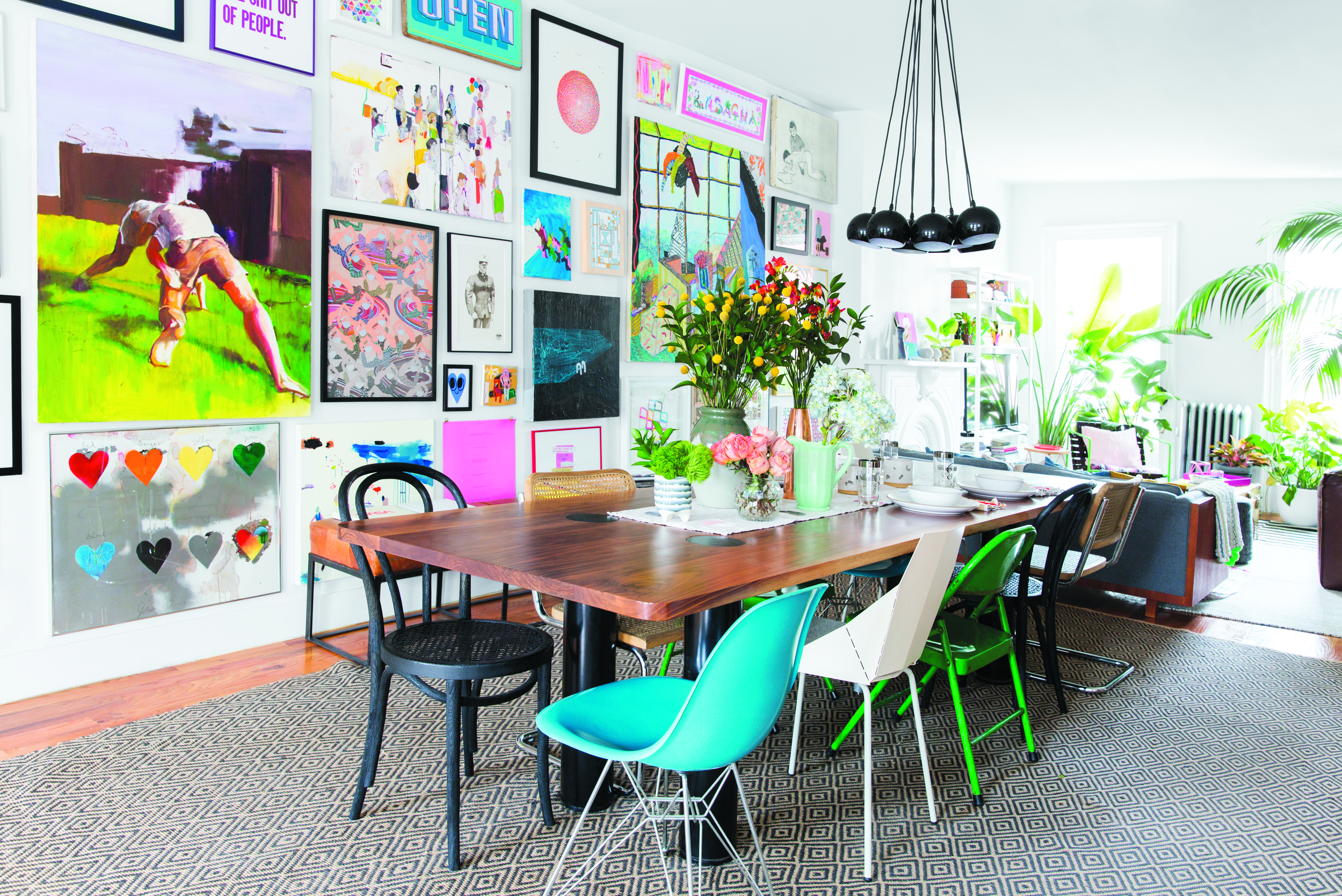 he dining room in Pelosi’s former Brooklyn apartment features a wall of art showcasing several RISD alums and a table he designed. Photo by Michael Wiltbank/Domino