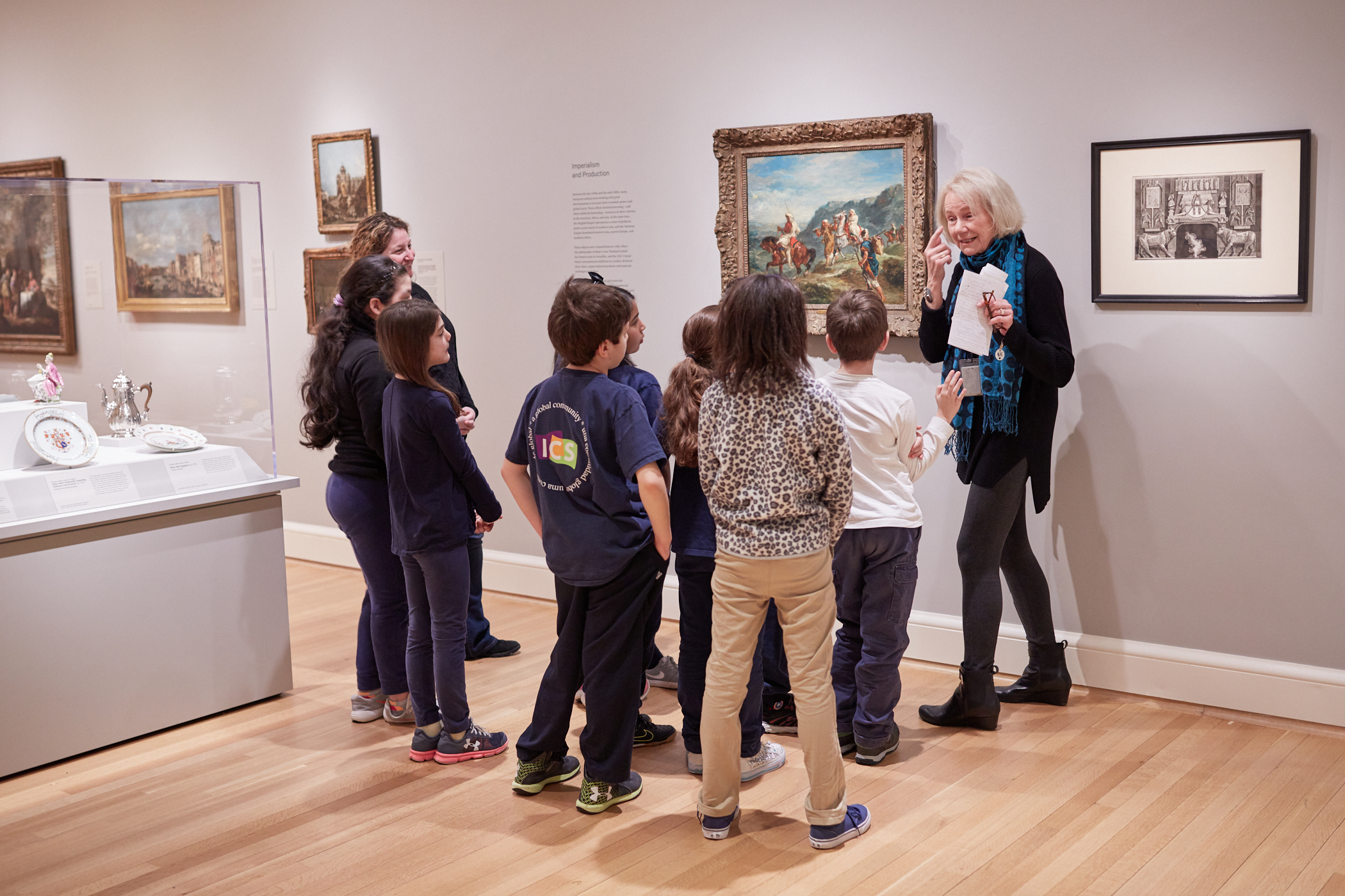 2018 Docent Jane Koster leading students from the International School on a tour in 2018. Photo by Erik Gould.