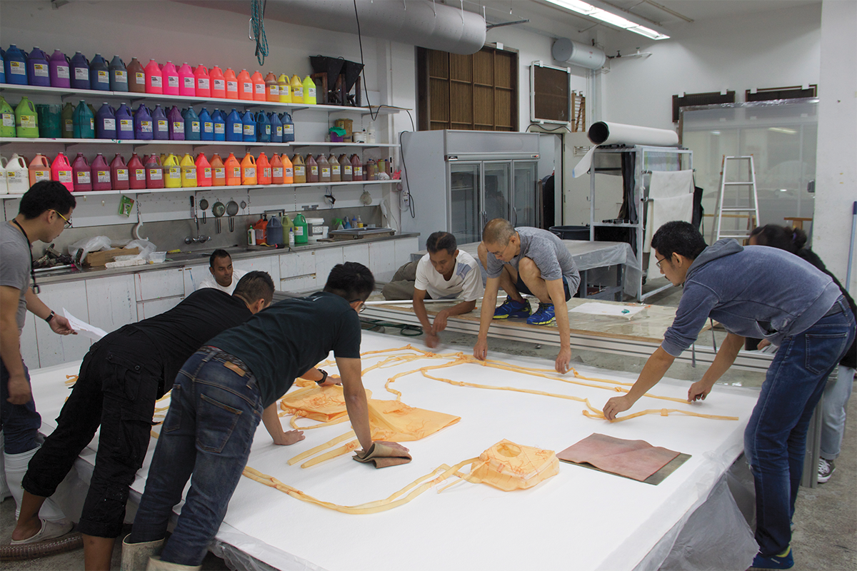 Do Ho Suh (center, in gray) at work at the STPI Creative Workshop & Gallery, Singapore, 2019. Courtesy of the artist and STPI.