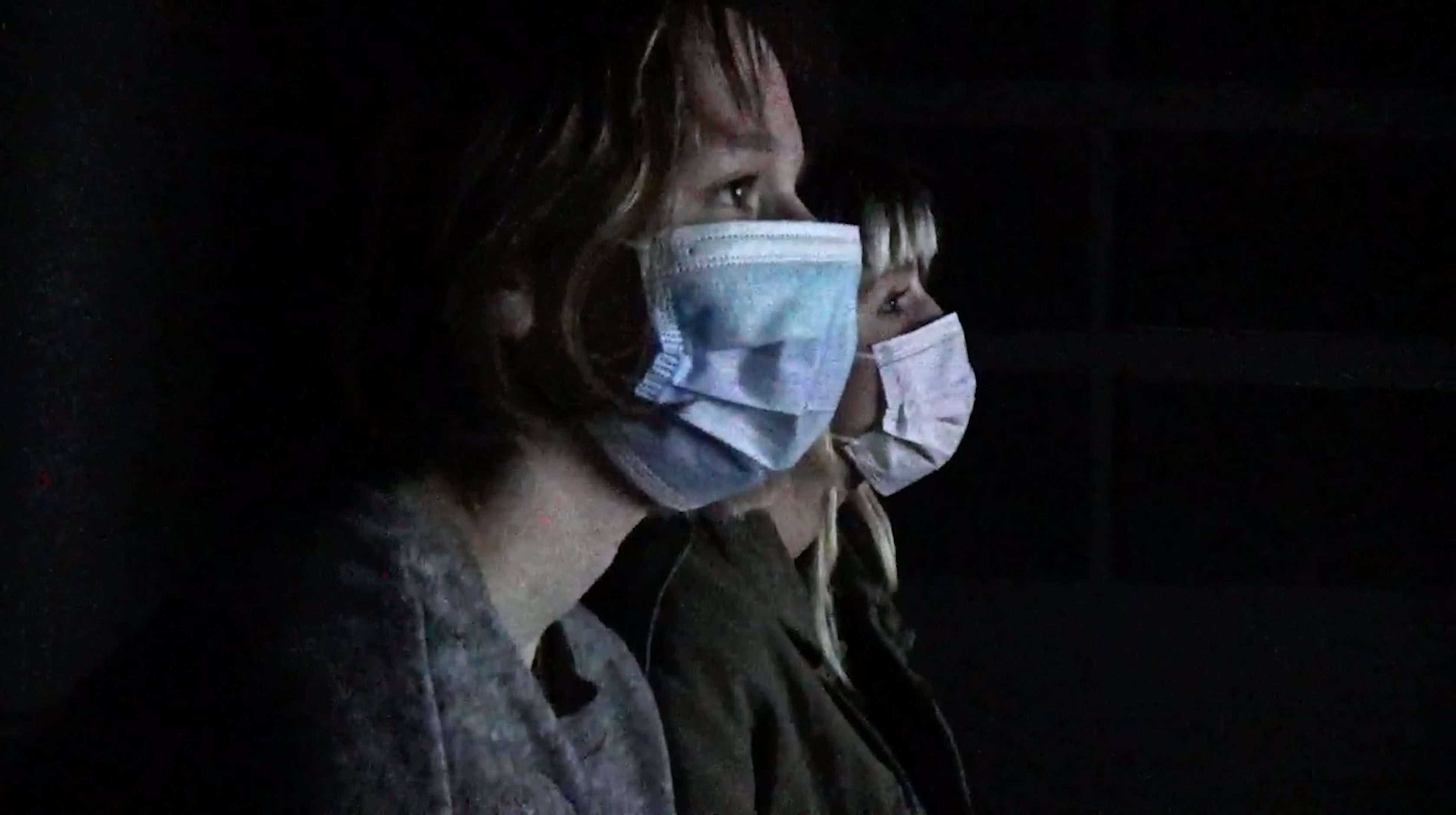 Students in a dark room with masks on 