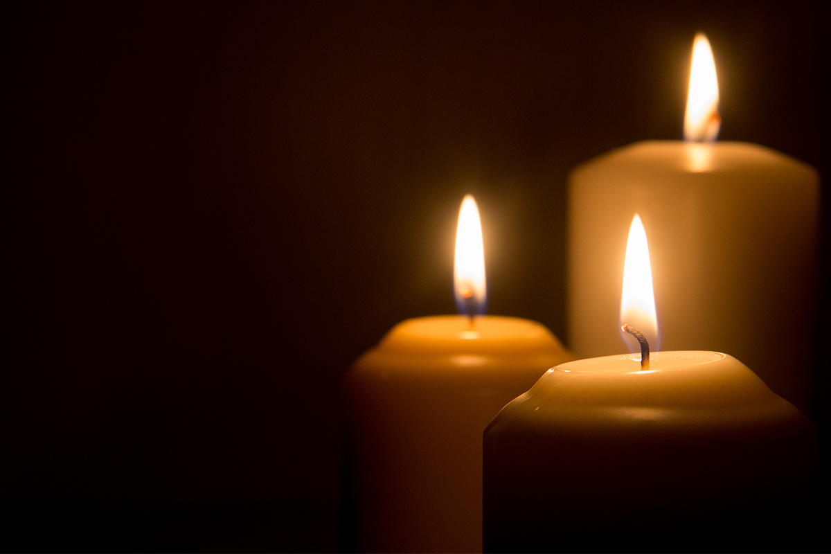 Lighted candles against a dark background