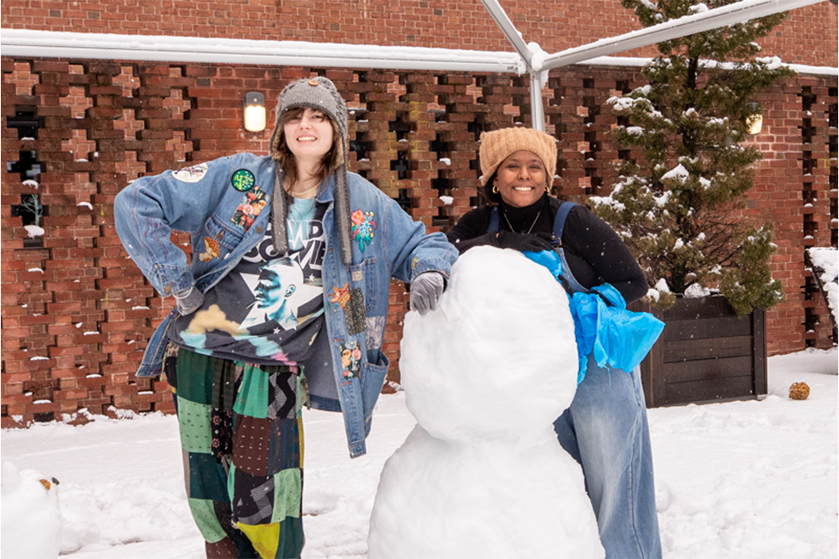 Two students making a snow person