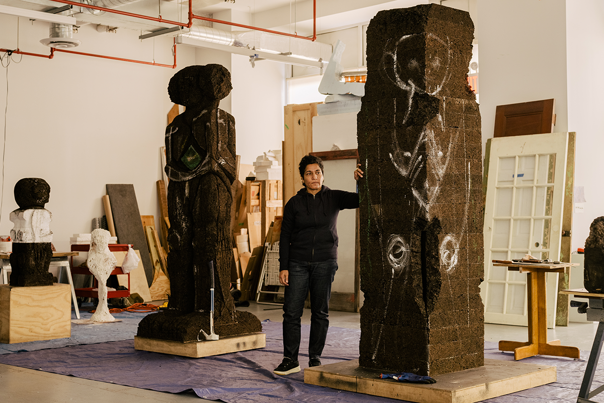 Huma F. Bhabha in the studio with two monumental sculptures