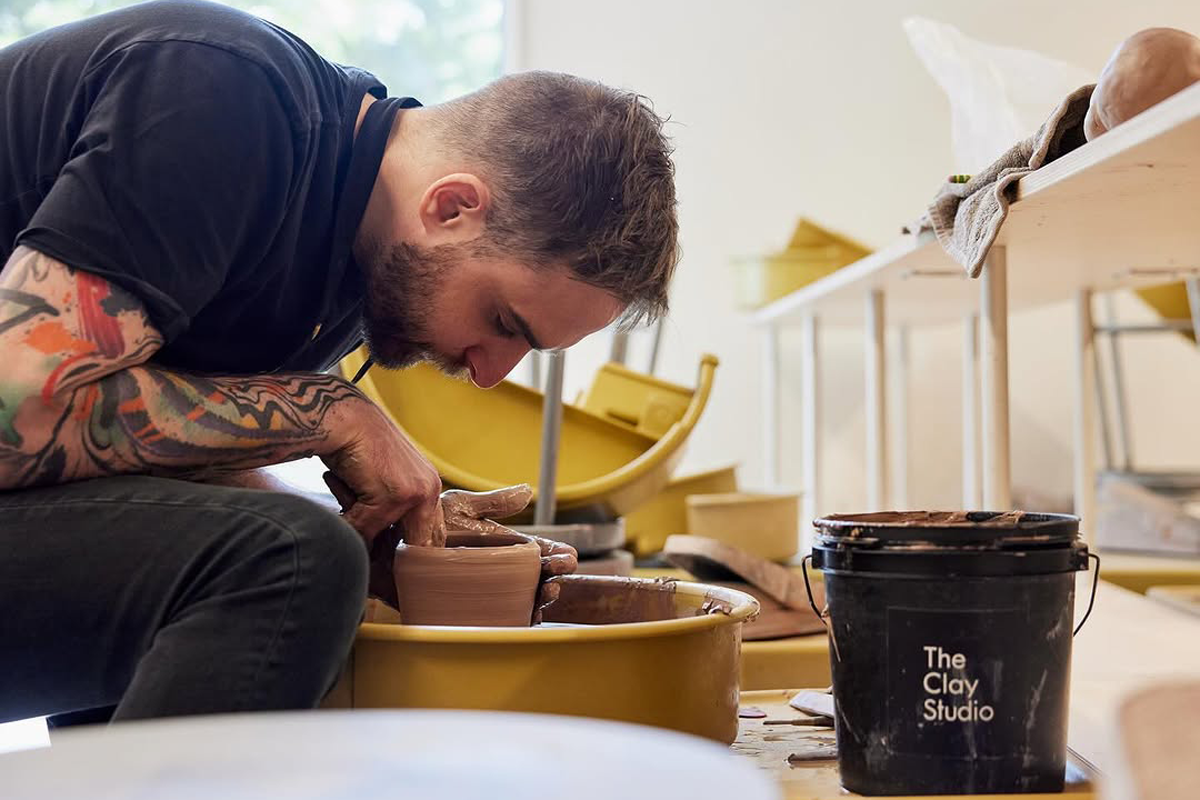 Person making a pot in a clay studio