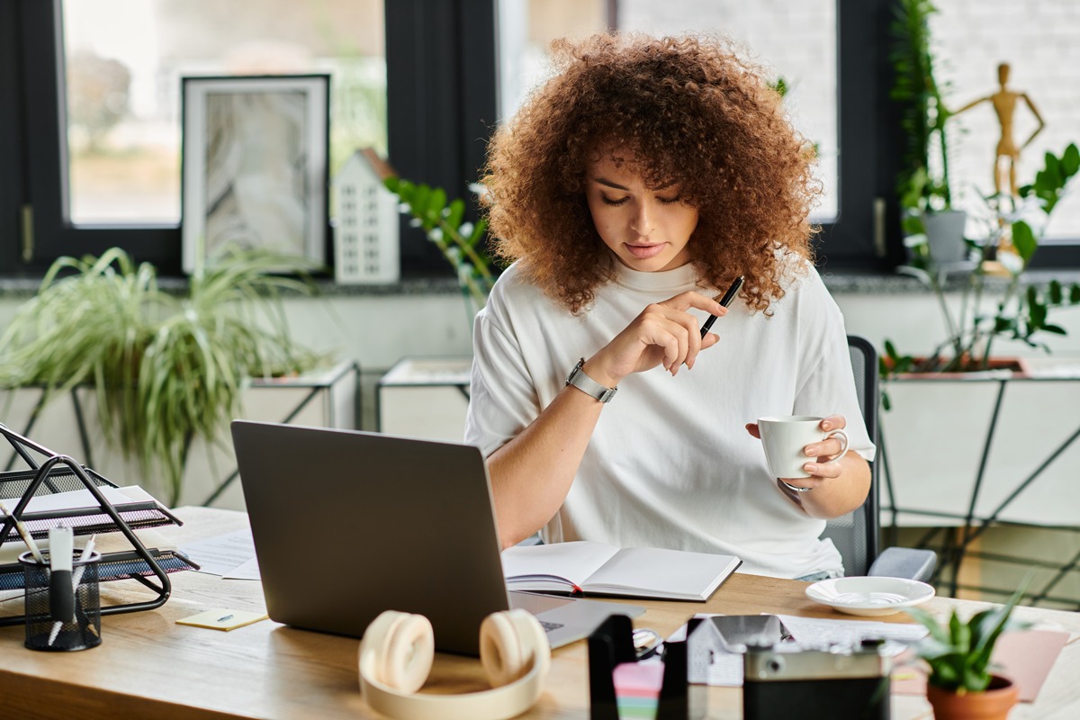 Woman at a table working on her laptop